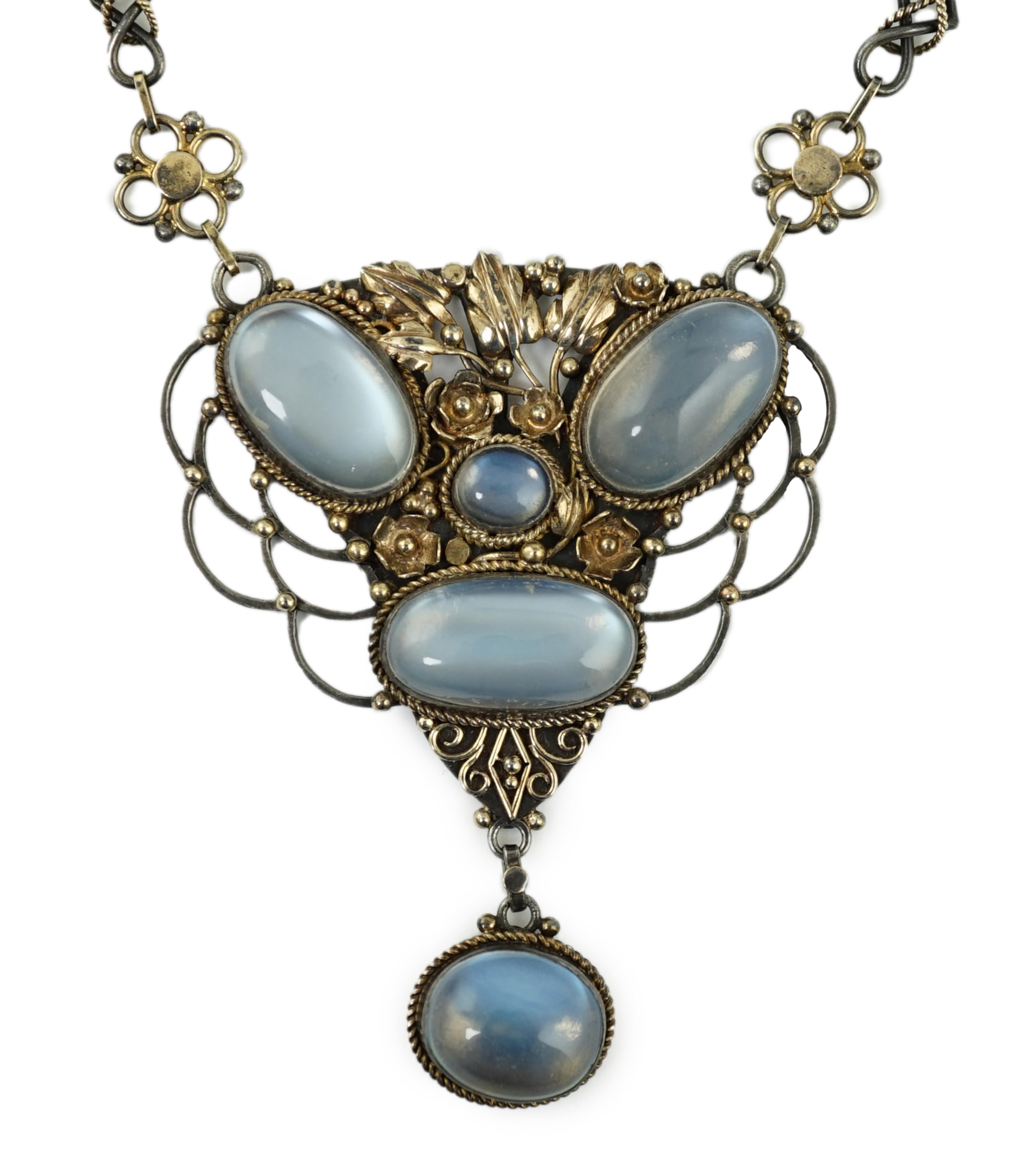 An early to mid 20th century Arts & Crafts pierced parcel gilt silver and five stone cabochon moonstone set drop pendant necklace